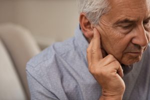 Senior man with hearing problems