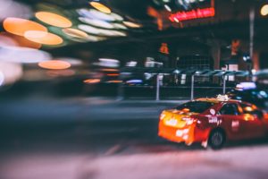 A nighttime image of a taxi, relating to rideshare safety and sexual assault prevention.